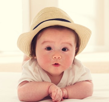 Happy baby boy with straw hat